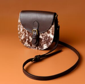 Chic leather sling bag with brown texture, perfect for stylish fashion statements.